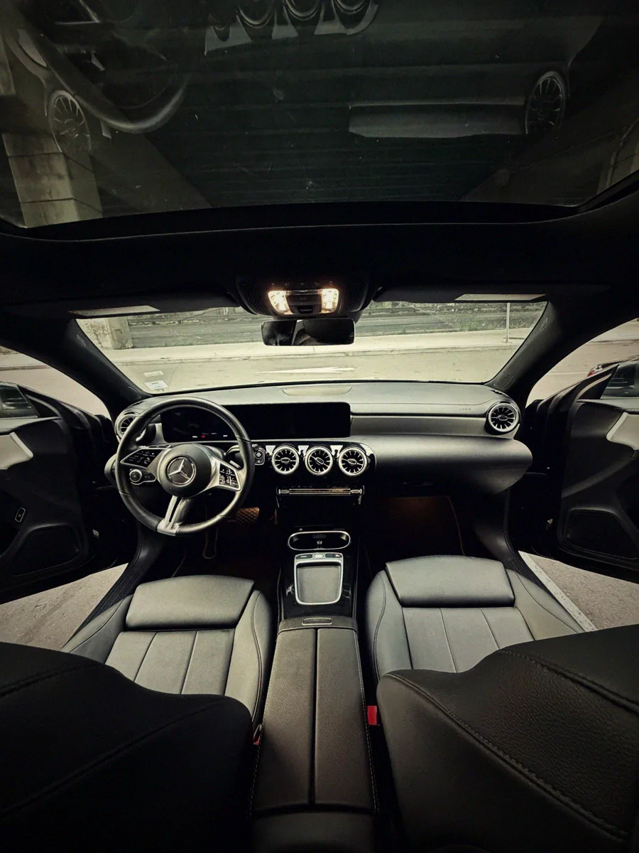The Mercedes dashboard from the back seat, clean